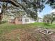 Back of house with stone, bay window, and fire pit at 307 Fern Cliff Ave, Temple Terrace, FL 33617