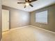 Bedroom with a window and ceiling fan, offering natural light and comfort at 307 Fern Cliff Ave, Temple Terrace, FL 33617