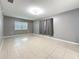 Neutral bedroom featuring tile floors, window, and curtain at 307 Fern Cliff Ave, Temple Terrace, FL 33617