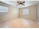 Well-lit bedroom features tile flooring and a ceiling fan at 307 Fern Cliff Ave, Temple Terrace, FL 33617