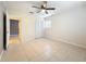 Well-lit bedroom with a tile floor, ceiling fan and closet at 307 Fern Cliff Ave, Temple Terrace, FL 33617