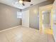 Cozy bedroom features closet space, a window, and ceiling fan at 307 Fern Cliff Ave, Temple Terrace, FL 33617