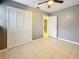 Bedroom with neutral walls, a fan, tile floors and double door closet at 307 Fern Cliff Ave, Temple Terrace, FL 33617