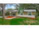 Beautiful single-story home featuring stone accents and a vibrant green lawn at 307 Fern Cliff Ave, Temple Terrace, FL 33617