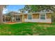 Charming single-story home with a stone facade and a well-manicured lawn at 307 Fern Cliff Ave, Temple Terrace, FL 33617