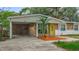 Inviting single-story home with a covered carport and attractive stone detailing at 307 Fern Cliff Ave, Temple Terrace, FL 33617