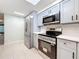 Updated kitchen featuring stainless steel appliances, granite countertops, and ample cabinet space at 307 Fern Cliff Ave, Temple Terrace, FL 33617