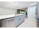Updated kitchen boasts stainless steel appliances, a modern faucet, and white backsplash at 307 Fern Cliff Ave, Temple Terrace, FL 33617