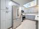 Modern kitchen with stainless steel refrigerator, ample storage, and recessed lighting at 307 Fern Cliff Ave, Temple Terrace, FL 33617