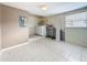 Clean laundry room with white washer/dryer and tile flooring at 307 Fern Cliff Ave, Temple Terrace, FL 33617