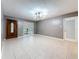 Bright living room features a large window, tile floors, and a front door with decorative glass at 307 Fern Cliff Ave, Temple Terrace, FL 33617