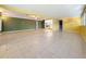 Spacious living room with tile flooring, neutral paint, and a view into the kitchen at 307 Fern Cliff Ave, Temple Terrace, FL 33617
