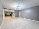 Spacious living room with modern chandelier and tile flooring throughout the home at 307 Fern Cliff Ave, Temple Terrace, FL 33617