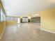 Expansive living room with tile flooring, large windows, and bright, two-toned paint at 307 Fern Cliff Ave, Temple Terrace, FL 33617