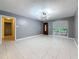 Well-lit living room with neutral walls, tile flooring, and a view to a side entryway at 307 Fern Cliff Ave, Temple Terrace, FL 33617