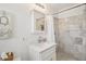 Bathroom with white vanity, framed mirror, and tiled walk-in shower at 316 Cedar Ln, Largo, FL 33770