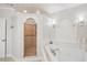 Elegant bathroom with a whirlpool tub and a tiled walk-in shower with a glass door at 316 Cedar Ln, Largo, FL 33770