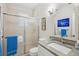Bright bathroom with granite countertops and a shower with glass door at 316 Cedar Ln, Largo, FL 33770