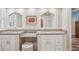 Bright bathroom features double sinks, granite counters, and white cabinets at 316 Cedar Ln, Largo, FL 33770