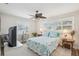 Bright bedroom with large windows, ceiling fan, and stylish decor at 316 Cedar Ln, Largo, FL 33770