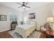 Comfortable bedroom with hardwood floors, ceiling fan, and ample natural light at 316 Cedar Ln, Largo, FL 33770