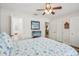 Comfortable bedroom with ceiling fan and en suite bathroom access at 316 Cedar Ln, Largo, FL 33770