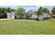 Traditional-style house showcasing mature landscaping and a well-manicured front yard at 316 Cedar Ln, Largo, FL 33770