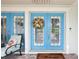 Inviting entrance with double doors, colorful wreath, and comfortable seating at 316 Cedar Ln, Largo, FL 33770