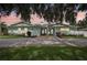 Charming light blue home featuring double doors, a brick driveway and mature landscaping at 316 Cedar Ln, Largo, FL 33770