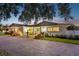 Charming single-story home with brick driveway, well-maintained landscaping, and a welcoming front entrance at 316 Cedar Ln, Largo, FL 33770