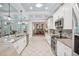 Modern kitchen with stainless steel appliances, island with seating, and stylish backsplash at 316 Cedar Ln, Largo, FL 33770