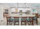 Bright kitchen with large island, seating, stainless steel appliances, and tile flooring at 316 Cedar Ln, Largo, FL 33770