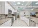 Open kitchen with stainless steel appliances, granite countertops, and ample cabinet space at 316 Cedar Ln, Largo, FL 33770