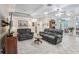 Bright living room with modern furniture, recessed lighting, and access to other areas of the home at 316 Cedar Ln, Largo, FL 33770