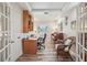 Inviting home office featuring wood floors, a desk, shelving, and a charming seating area at 316 Cedar Ln, Largo, FL 33770