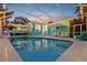 Beautiful screened-in pool area with ample seating and lovely sunset views at 316 Cedar Ln, Largo, FL 33770
