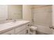 Cozy bathroom featuring vanity, tub, and toilet, perfect for a relaxing retreat at 33063 Tulip Petal Ln, Wesley Chapel, FL 33545