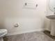 Half-bath with tile floors, pedestal sink, and neutral wall paint at 33063 Tulip Petal Ln, Wesley Chapel, FL 33545