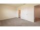 This is a bedroom with a door to the bathroom and carpet flooring at 33063 Tulip Petal Ln, Wesley Chapel, FL 33545