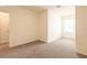 Spacious bedroom with neutral walls, carpet, and ample natural light from a window at 33063 Tulip Petal Ln, Wesley Chapel, FL 33545