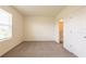 This is a bedroom with a door to the bathroom and carpet flooring at 33063 Tulip Petal Ln, Wesley Chapel, FL 33545