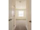 Hallway view into a carpeted bedroom with a window providing natural light at 33063 Tulip Petal Ln, Wesley Chapel, FL 33545