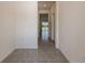 Hallway with tiled floors and view to the backyard at 33063 Tulip Petal Ln, Wesley Chapel, FL 33545