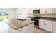 Granite countertops accent this spacious kitchen with a range, microwave, and tile floors at 33063 Tulip Petal Ln, Wesley Chapel, FL 33545
