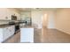 Modern kitchen with stainless steel appliances, granite countertops, island, and tile flooring at 33063 Tulip Petal Ln, Wesley Chapel, FL 33545
