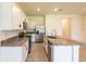A bright kitchen with granite countertops, stainless steel appliances, tile floors and an island at 33063 Tulip Petal Ln, Wesley Chapel, FL 33545