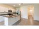Stylish eat-in kitchen with stainless steel appliances, granite counters and a large island for seating at 33063 Tulip Petal Ln, Wesley Chapel, FL 33545