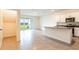 Modern kitchen with granite countertops, stainless steel appliances, island and access to the backyard patio at 33063 Tulip Petal Ln, Wesley Chapel, FL 33545