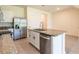 Contemporary kitchen with stainless steel dishwasher and refrigerator, and granite countertops at 33063 Tulip Petal Ln, Wesley Chapel, FL 33545