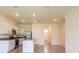 Open-concept kitchen area with tile floors, island, and stainless steel appliances at 33063 Tulip Petal Ln, Wesley Chapel, FL 33545